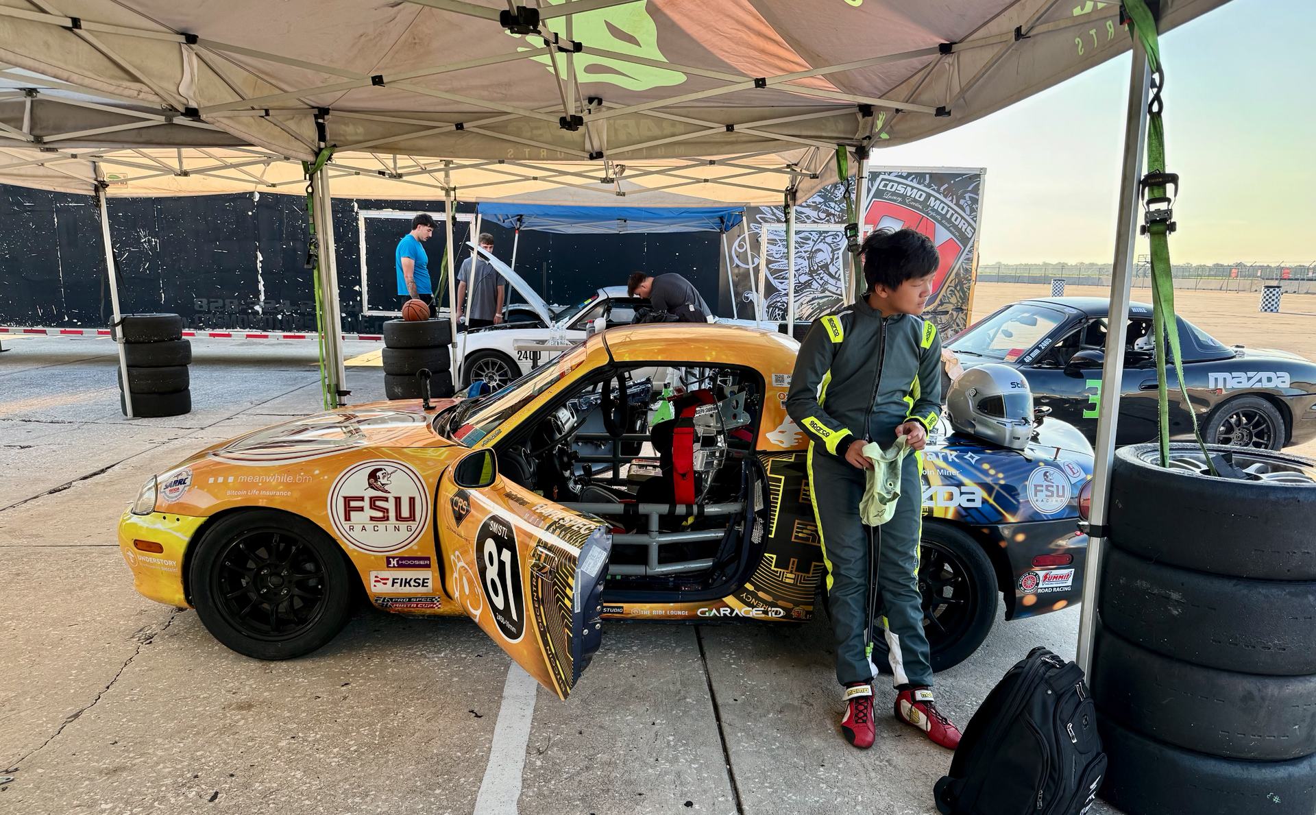 The founder's driver beside the #81 Spec Miata in the Sebring paddock
